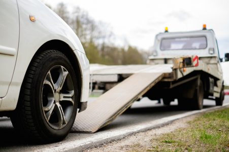 Car being loaded onto tow truck