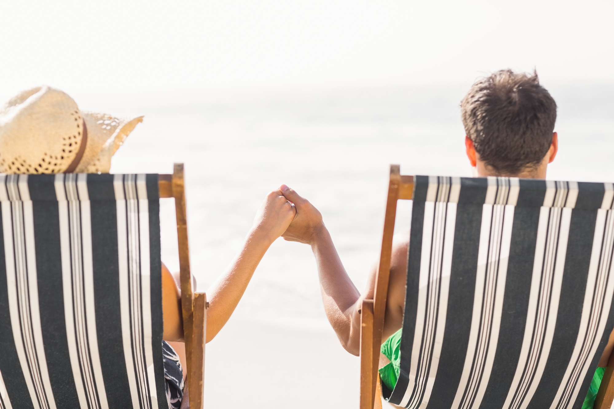 New-Era-Debt-Solutions-Couple-Relaxing-On-Beach