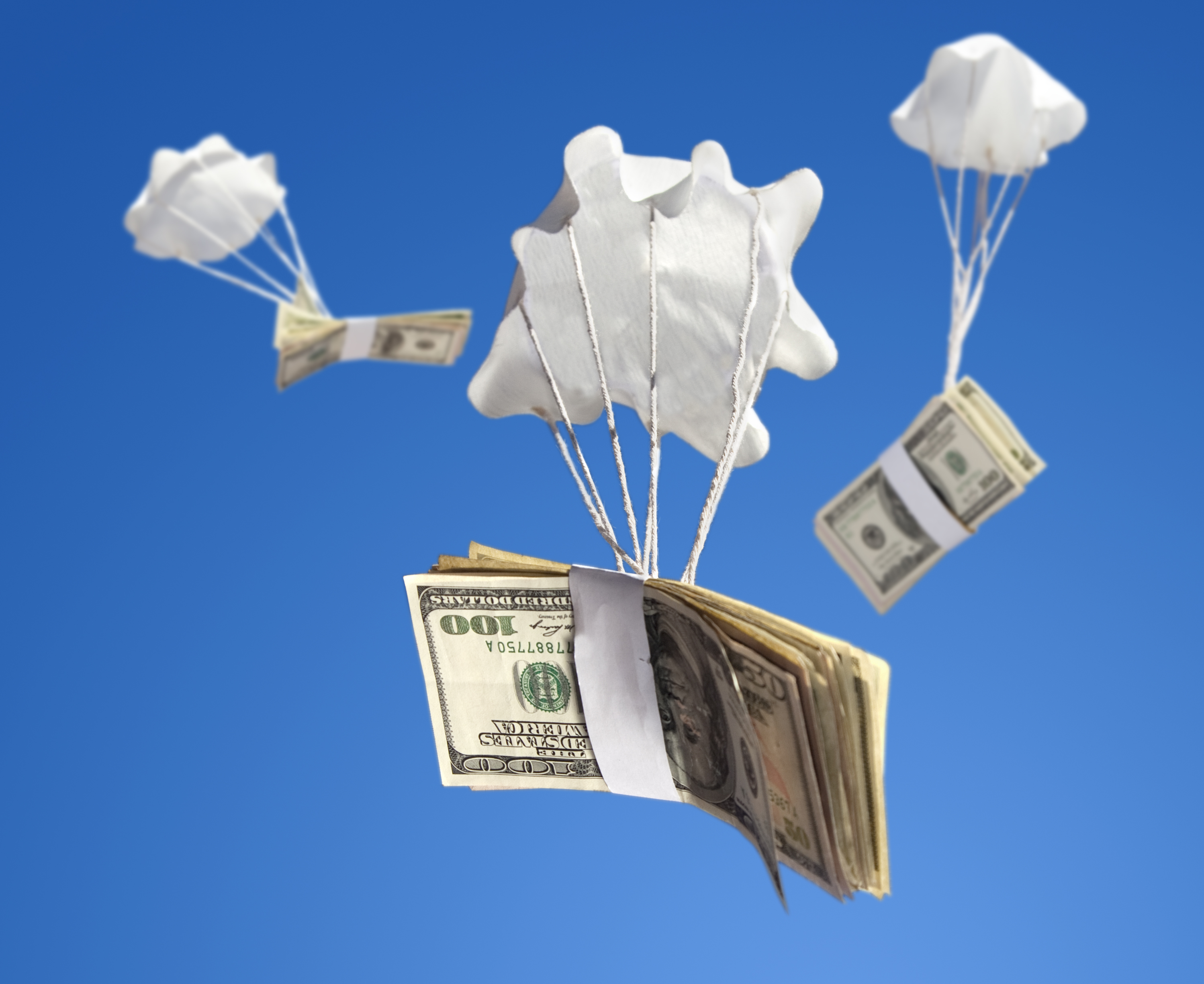 Bailout money falling from the sky on parachutes.