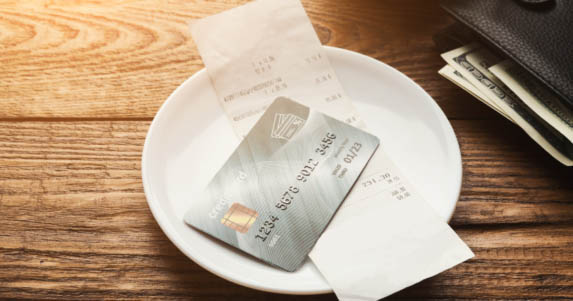 Credit card and receipt on plate