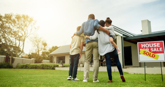 family in front of new home