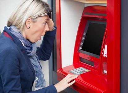 Shocked woman looking at her negative bank account balance